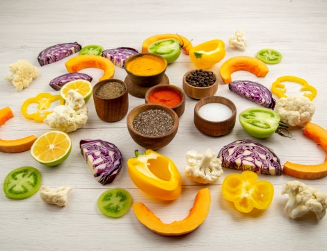 bottom-view-spices-bowls-cut-bell-pepper-cauliflower-cut-pumpkin-cut-red-cabbage-cut-green-tomatoes-table