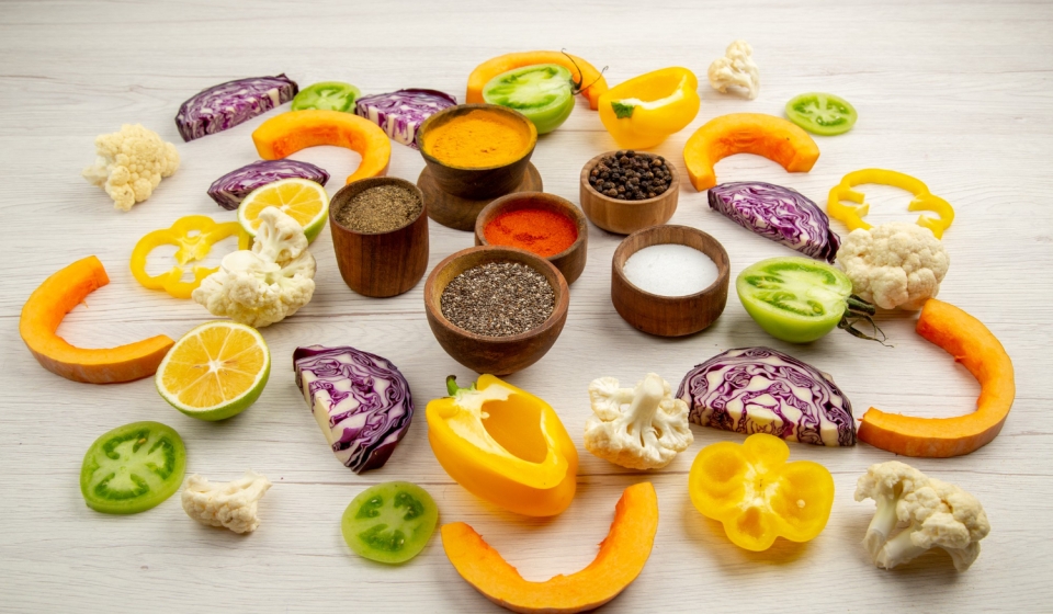 bottom-view-spices-bowls-cut-bell-pepper-cauliflower-cut-pumpkin-cut-red-cabbage-cut-green-tomatoes-table
